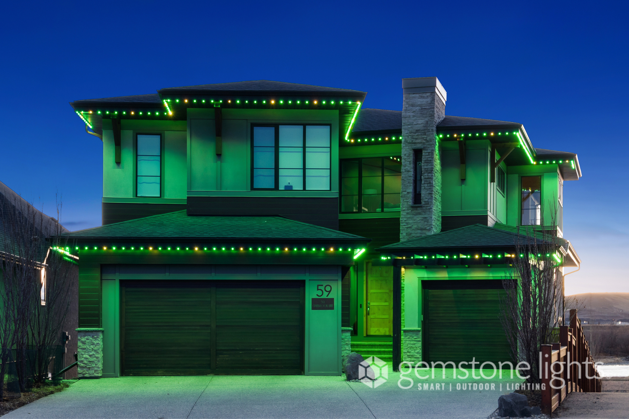 Two-storey Airdrie home with permanent Gemstone Lights soffit LED track installed by Calgary Permanent Lights