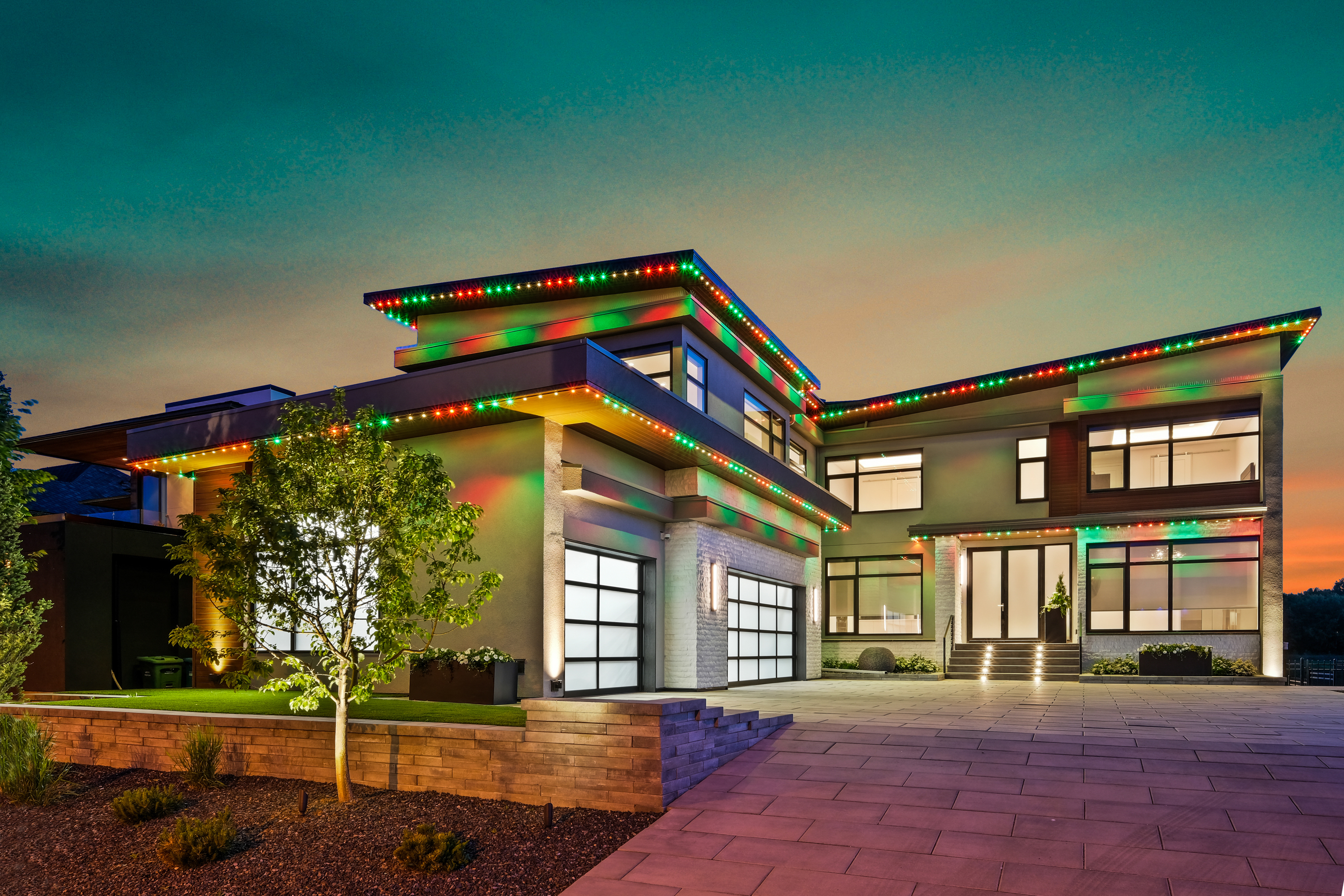 Calgary home with multicolour holiday Gemstone Lights LED roofline display — Calgary Permanent Lights, authorized Gemstone dealer